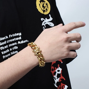 Macro view of gold hip hop Cuban link bracelet with rhinestone clasp for men