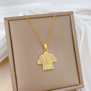 Detailed view of No. 10 jersey pendant with sparkling rhinestones on silk background