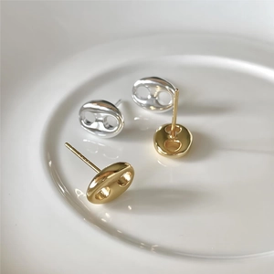Macro shot of 925 sterling silver pig nose stud earrings in gold and silver finishes