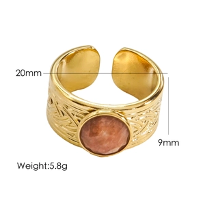 Detailed view of adjustable gold ring with faceted brown stone and braided texture