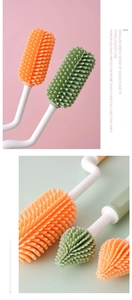 Close-up of flexible orange and green silicone brush heads for cleaning baby bottles