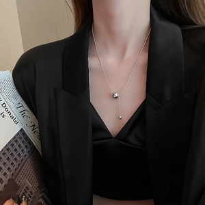 Elegant silver titanium steel necklace with ball pendant on snake chain worn by model