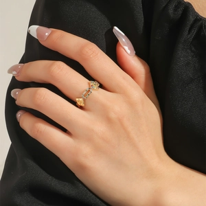 Detailed close-up of golden orbital ring featuring colorful micro-paved zircon stones