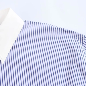 Detail view of blue and white striped shirt featuring a contrasting white collar neck