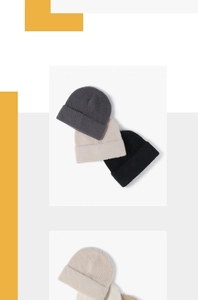 Close-up of soft feather yarn knit beanies in dark grey, beige, and black colors