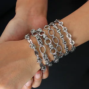 Close-up of assorted silver stainless steel link bracelets including pig nose and H designs