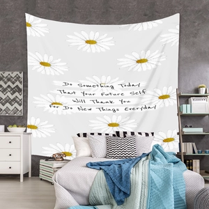 Detail of white daisy pattern and motivational text on bohemian wall tapestry