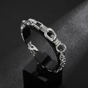 Detail of vintage silver chain bracelet featuring a rotating lock mechanism and ring