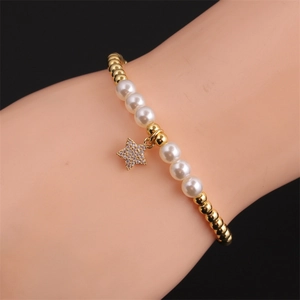 Elegant beaded bracelet featuring gold beads, white pearls, and a sparkling zircon star charm