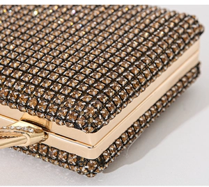 Macro view of champagne rhinestones and gold metal frame on the luxury evening bag