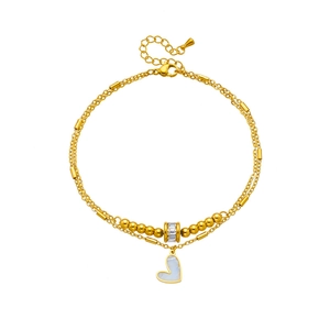 Gold double-layer anklet with heart pendant and sparkling rhinestone beads on white background