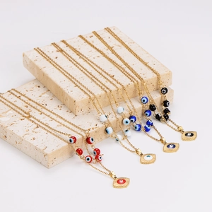 Golden stainless steel necklace set with evil eye beads and sun charms on stone
