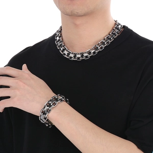 Close-up of interconnected 20mm woven hollow links on stainless steel necklace and bracelet