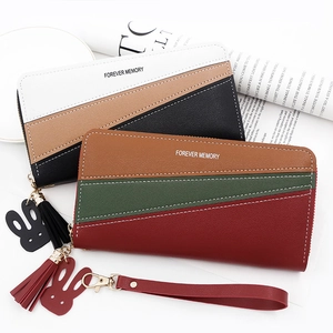 Close-up of tricolor patchwork leather long wallet with tassel and rabbit charm