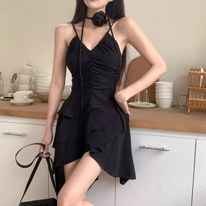 Detail of ruched slim fit black midi dress with layered hem and floral choker accessory