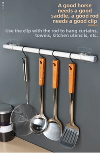 Adhesive wall mount rod holder with S-hooks displaying heavy stainless steel kitchen tools