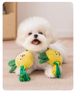 Macro shot of a dog pineapple plush toy with cotton rope knots and yellow corn fleece texture