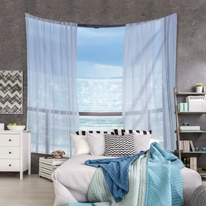 Detail of bohemian tapestry featuring a realistic ocean view with white sheer curtains