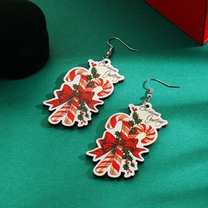 Detailed shot of Christmas candy cane earrings with red bows and holiday greetings
