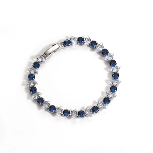 Detailed macro view of silver bracelet featuring blue round and clear marquise zircons