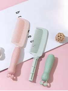 Close-up of rabbit-shaped handle and dense teeth of pink and green cartoon hair combs