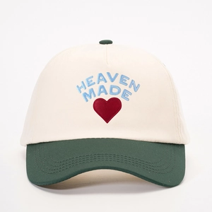 Two-tone baseball cap in off-white and dark green with HEAVEN MADE heart embroidery
