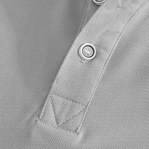 Macro shot of grey polo shirt placket showing button details and textured pique fabric