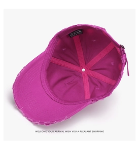 Internal view of distressed cotton baseball cap showing pink reinforced tape and logo label