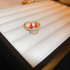 Close-up of golden dragon horn ring with red details and sparkling zircon accents