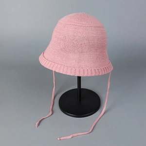 Detail of pink knit bucket hat showing breathable fine mesh texture and roll-up brim