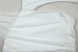 Close-up of white sheer mesh fabric texture and layered seam details on a dress