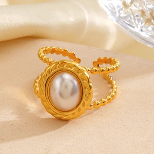 Vintage golden stainless steel ring with oval pearl and twisted rope detail