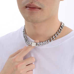 Close-up of 13mm silver stainless steel Cuban link necklace worn by a male model