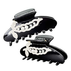 Set of two elegant black acetate hair claws with white pearls and sparkling rhinestones