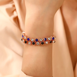 Detail shot of double-row rose gold bracelet with blue, black and clear round zircons