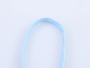 Detailed close-up of a light blue fabric strap with high-quality stitching and texture
