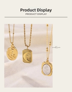 Detailed close-up of vintage gold embossed rose and moon pendants on elegant chains