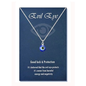 Detail of blue evil eye charm pendant on silver chain with protective message card