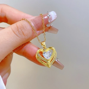Detail of gold heart pendant with sparkling zircon and I love you forever engraving