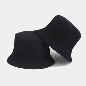 Detail shot of black corduroy and plain fabric bucket hat showing premium texture