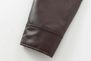 Detail shot of the dark brown faux leather bomber jacket showing cuffs and stitching