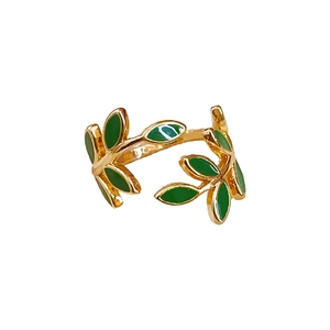 Retro golden leaf open ring with green enamel leaves on a clean white background