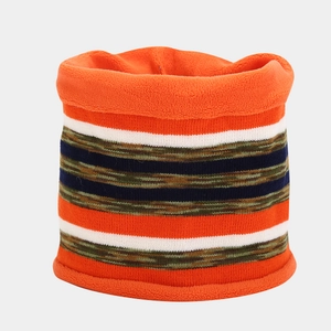 Detail of warm orange knitted neck warmer with striped pattern and soft fleece lining