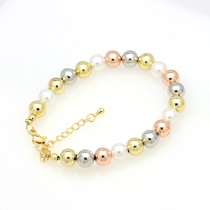 Close-up of tri-color metal beads and white pearls bracelet with adjustable gold chain