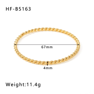 Detailed view of 18K gold plated twisted bangle with 67mm diameter specifications