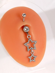 Detailed view of navel ring with white zircon and sparkling star pendants on silicone model
