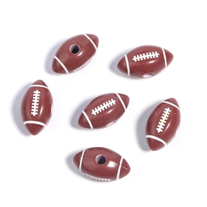 Macro shot of brown acrylic rugby beads with white stitching for DIY jewelry making