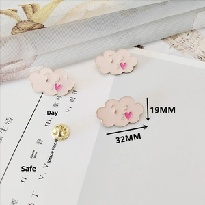 Detailed view of pink cloud enamel brooch with heart motif measuring 32mm by 19mm