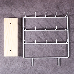 White metal jewelry display stand with wooden base featuring three tiers and 15 hooks