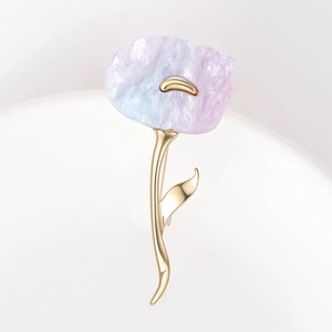 Macro detail of alloy flower brooch with pink-blue gradient petals and gold-tone stem